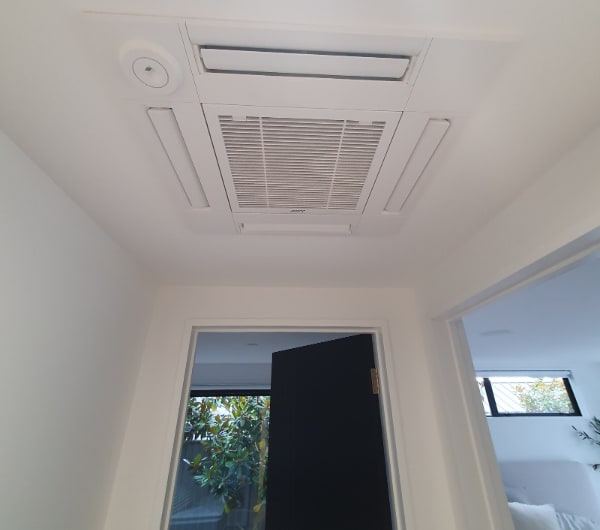 A ceiling cassette heat pump installed in the hallway of a finished Otago home