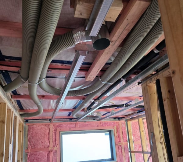 Heat recovery ventilation ductwork run through the framing of an Otago new build at first fix