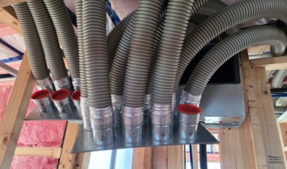 Heat recovery ventilation ductwork branching from the distribution plenum in an Otago new build
