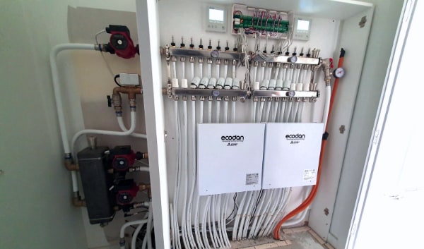 A hydronic heating plant cabinet in an Otago new build, with manifold, pumps and controls