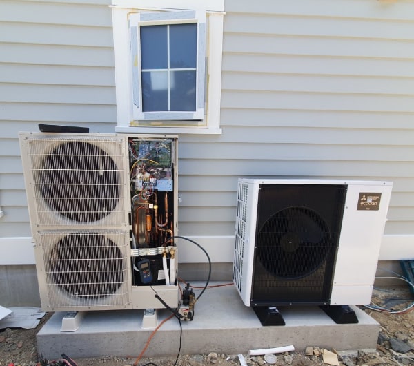 Two air-to-water heat pump outdoor units being commissioned at an Otago new build